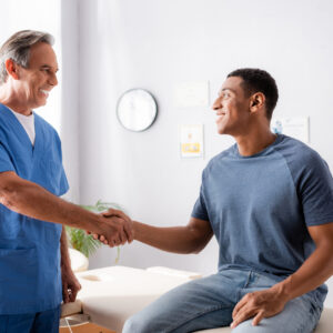 Happy,Chiropractor,Shaking,Hands,With,African,American,Patient